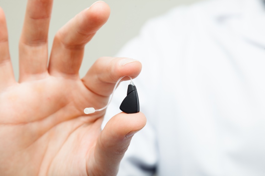 Small digital hearing aid in hand