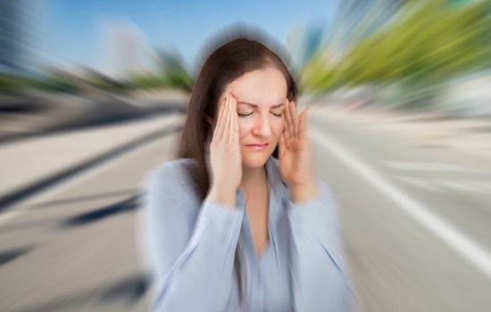 Woman holding her hands up to her forehead exhausted