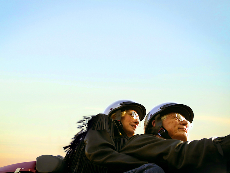 Couple enjoying their motorcycle while protecting their ears from further hearing loss.