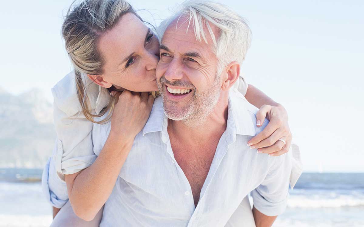 Middle aged happy couple looking young despite hearing loss.