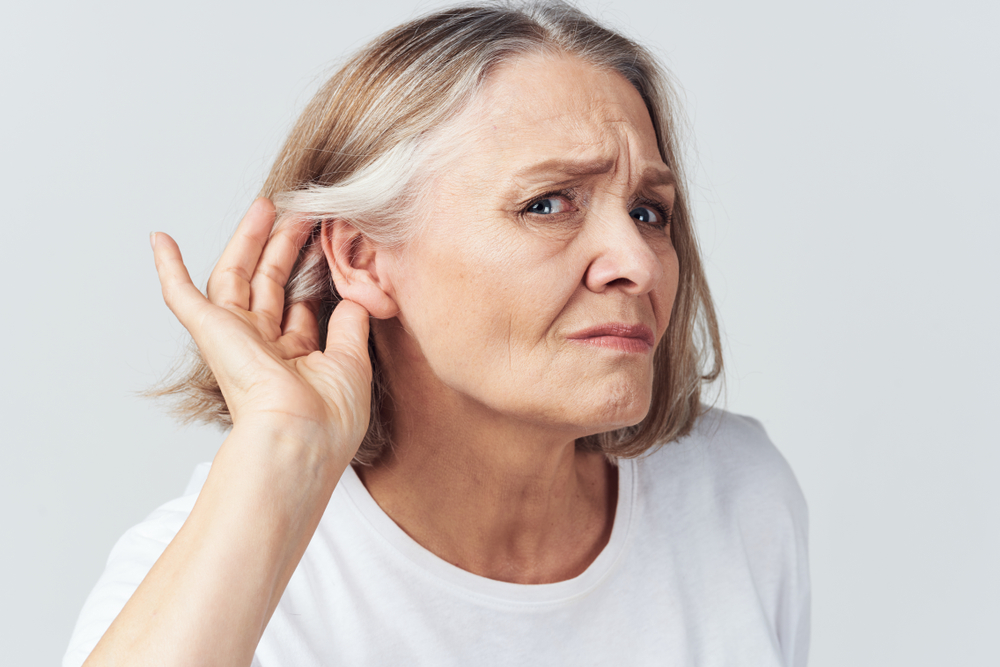 mature woman suffering from hearing loss.