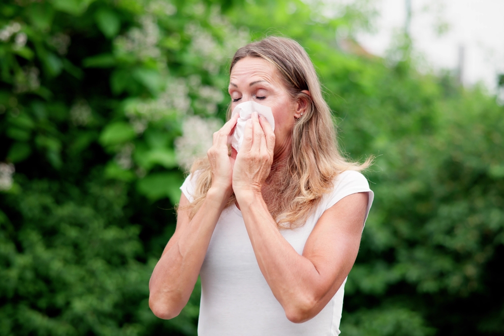 woman suffering from summer or spring allergies.