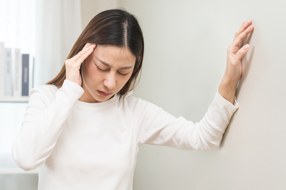 woman suffering from balance issue and dizziness.