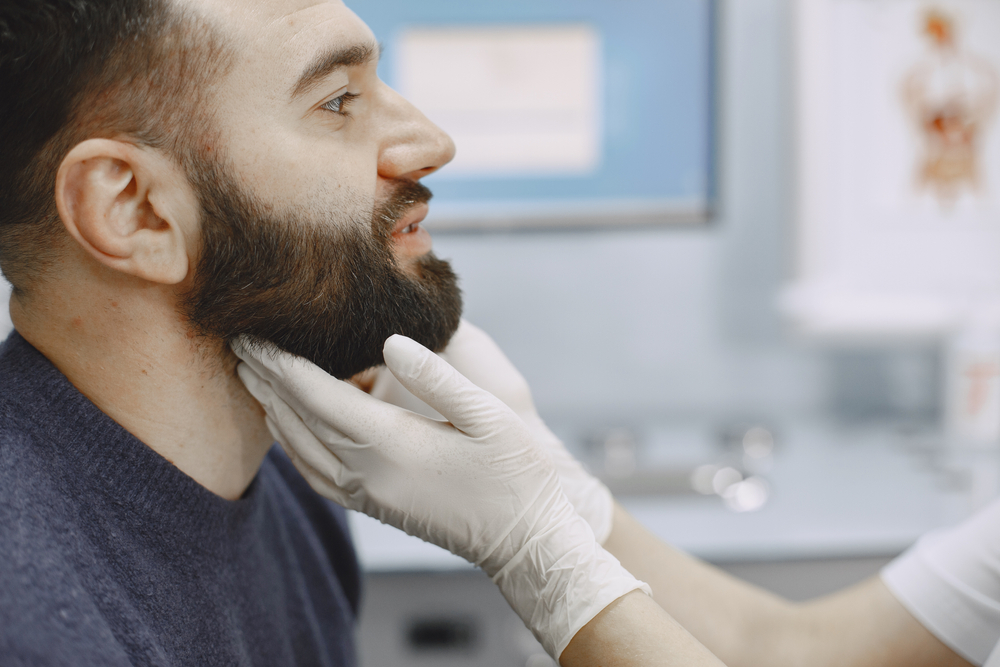 doctor evaluating patient's nose.