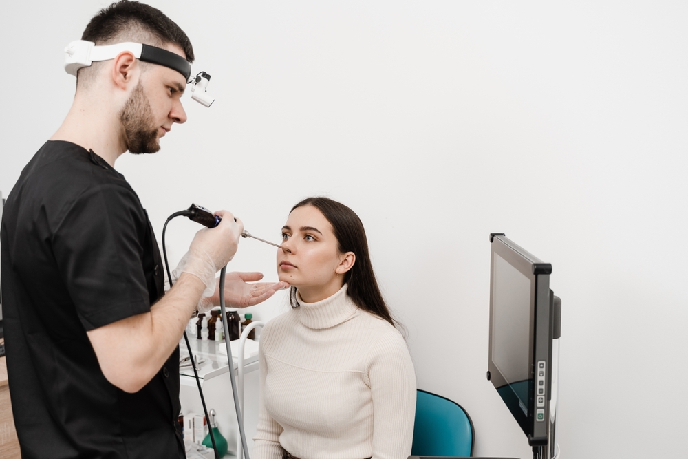 ENT doctor performing Nose endoscopy on female patient.