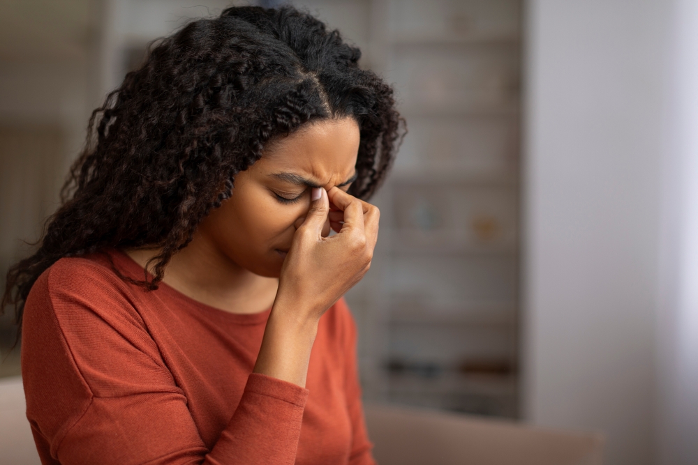 woman experiencing sinus headache pain.