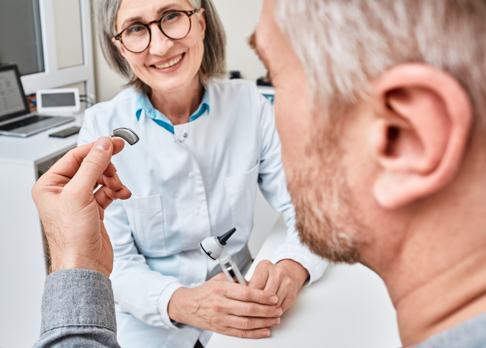 Male patient getting his hearing aid in hearing specialist clinic.