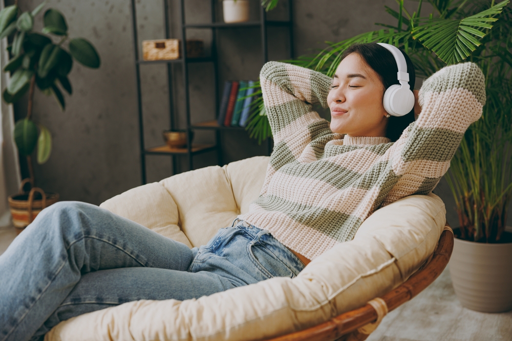 young calm woman listens to music in headphones.