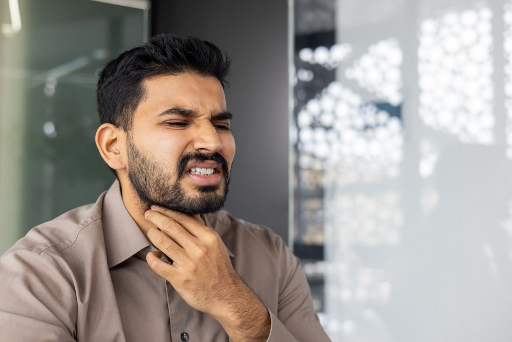 man in office with vocal issues.