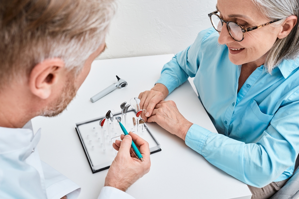 patient looking at hearing aid options with hearing specialist.