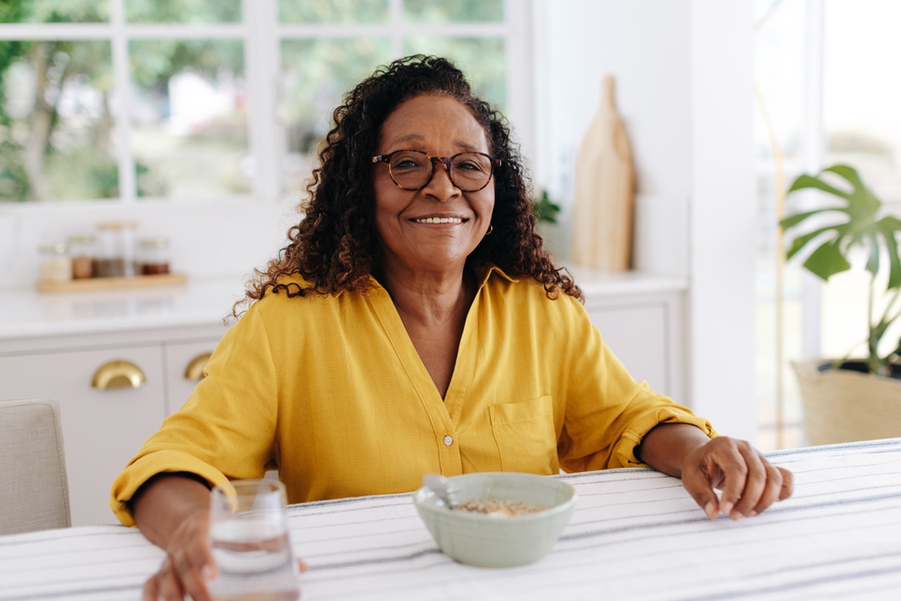 woman enjoys a healthy breakfast at home, having cereal and water..