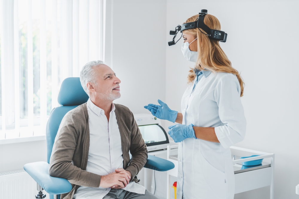 Woman otolaryngologist discussing with her patient problems who visiting clinic.