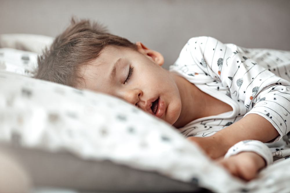 little boy sleeping with mouth open.