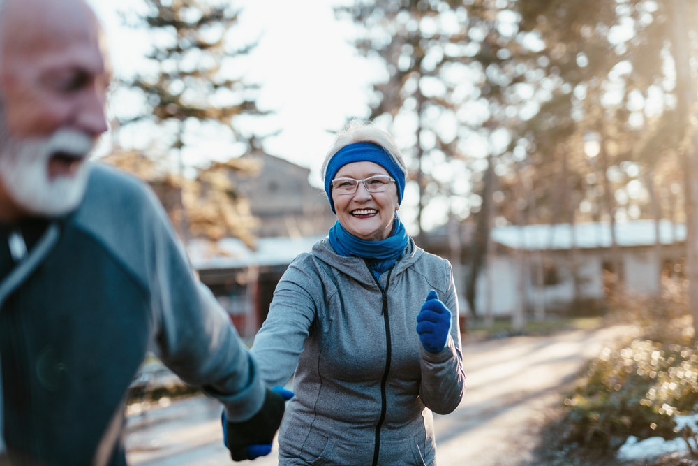 couple enjoys exercising and jogging on a cold, but sunny winter day.