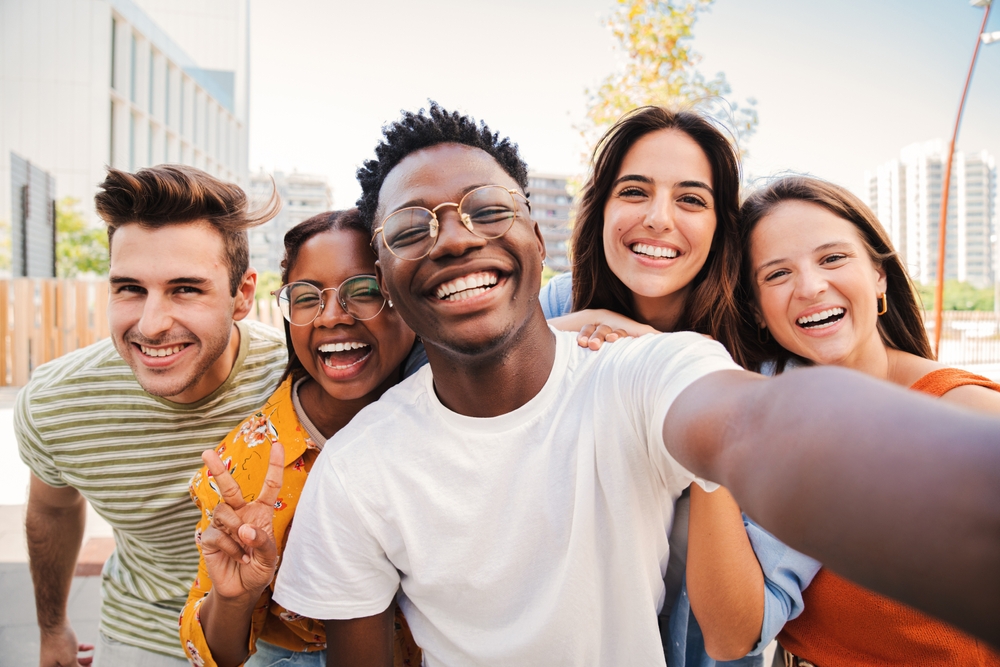 Group of multiracial young student people smiling and taking a selfie together.