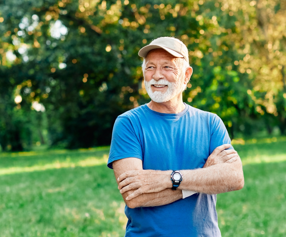 Portrait of a happy active senior posing after exercising outdoors.